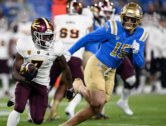 Arizona State Sun Devils wide receiver Melquan Stovall (7) runs against UCLA Bruins defensive lineman Laiatu Latu (15) at the Rose Bowl.